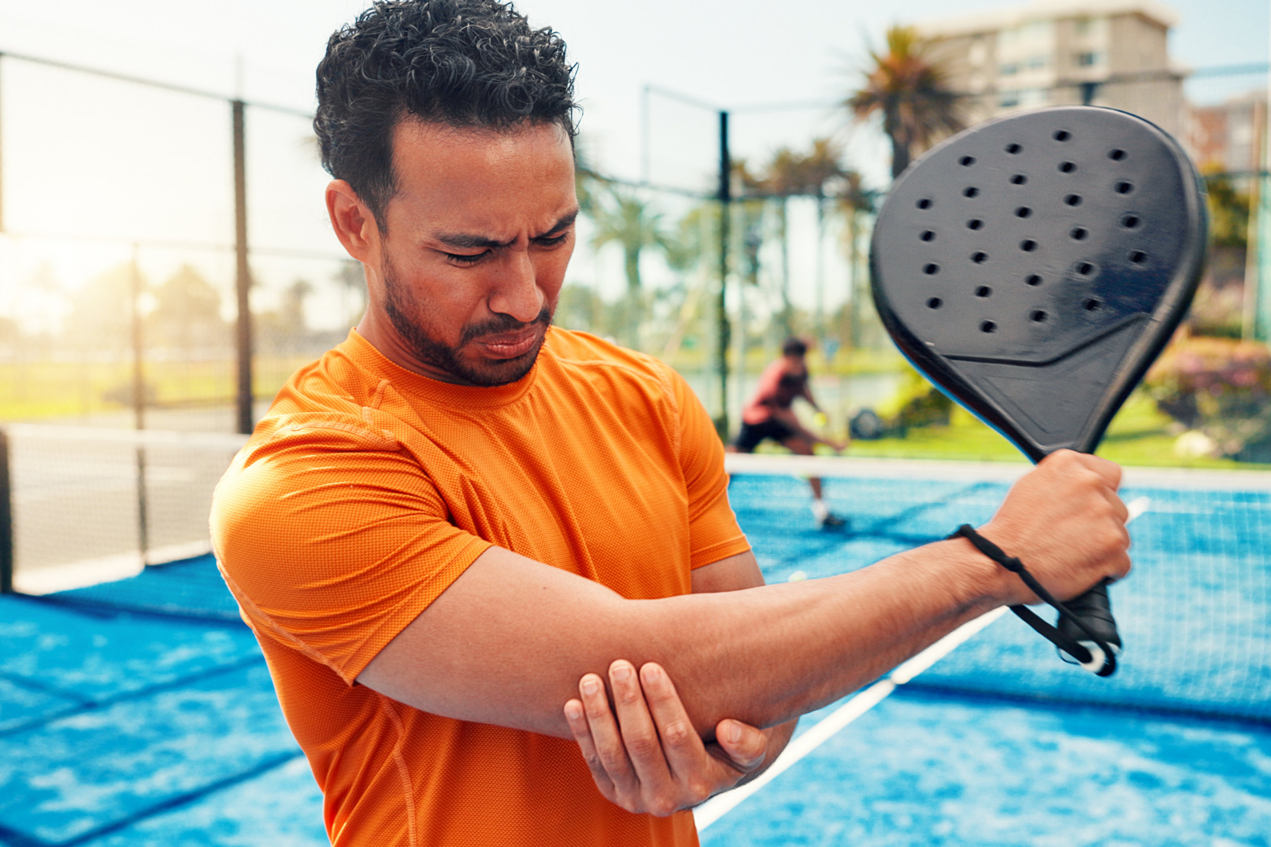 man with injured arm playing sports